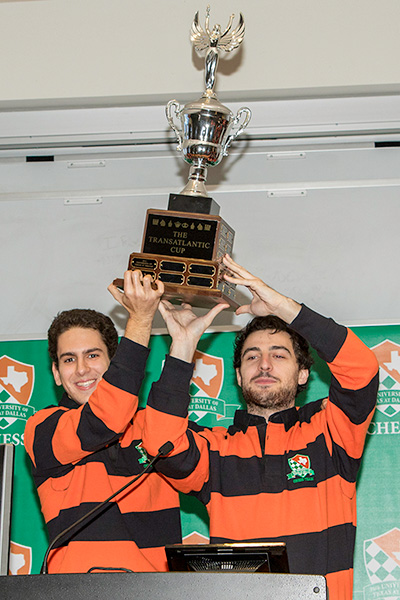 Chess Team members hoist a trophy