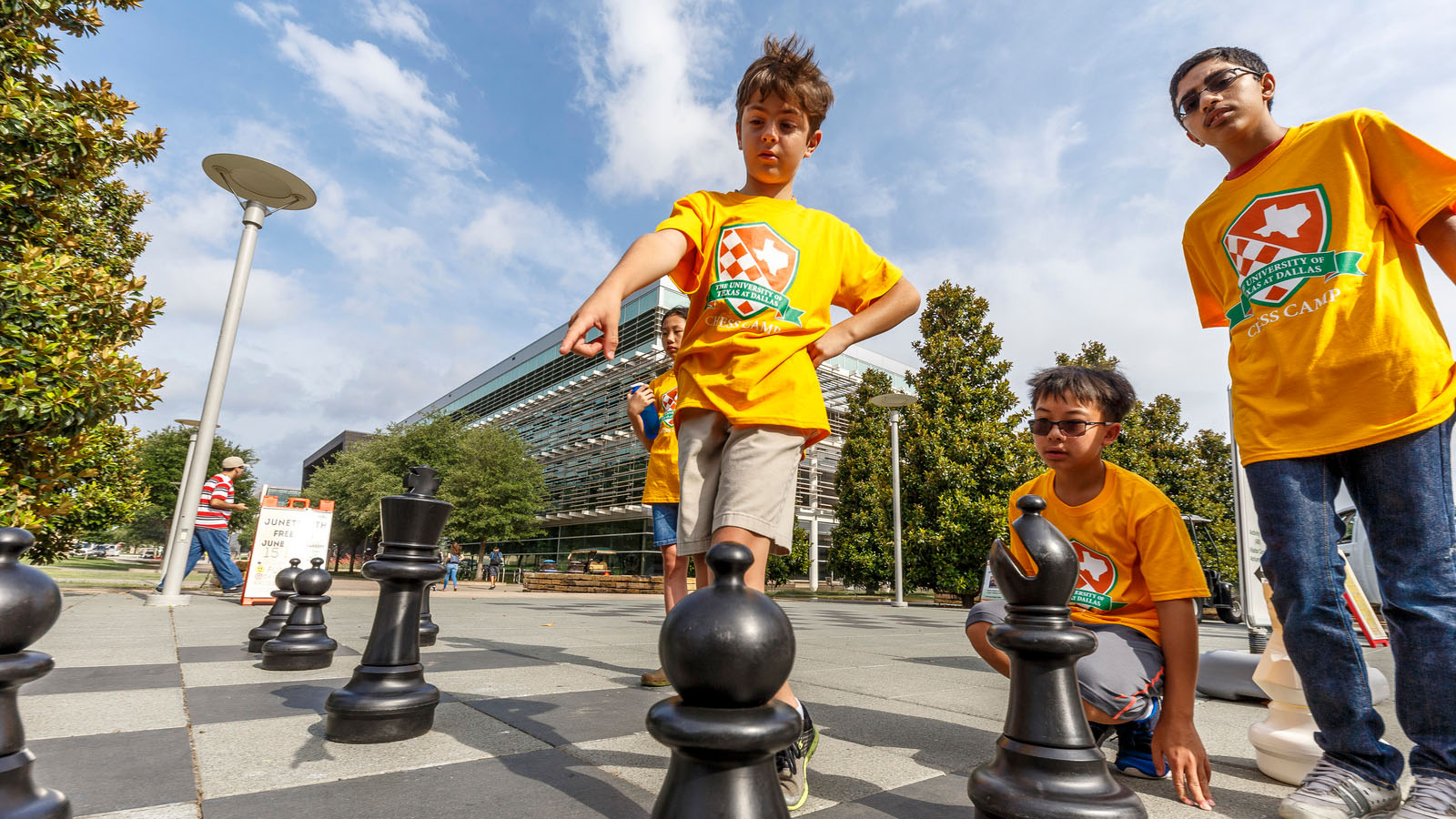 Children playing with life-size chess pieces at Chess Plaza