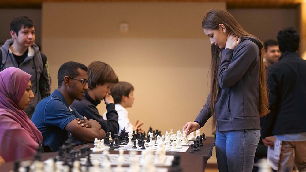 A Chess Team member plays a game against UTD students.